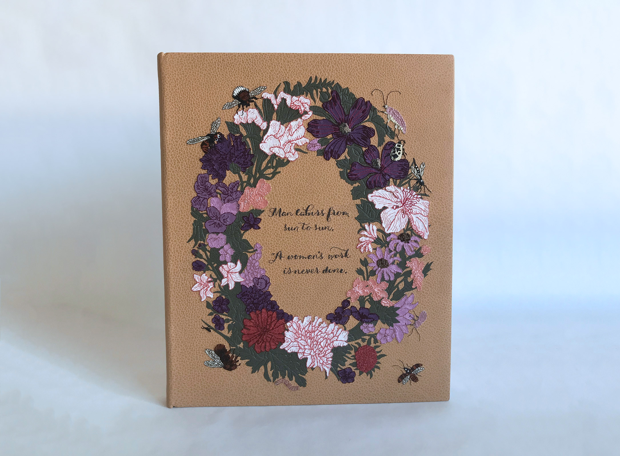 Front cover of Five Hundred Years of Women’s Work binding on a white table.