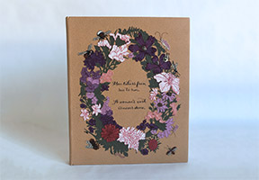 Front cover of Five Hundred Years of Women’s Work binding on a white table.