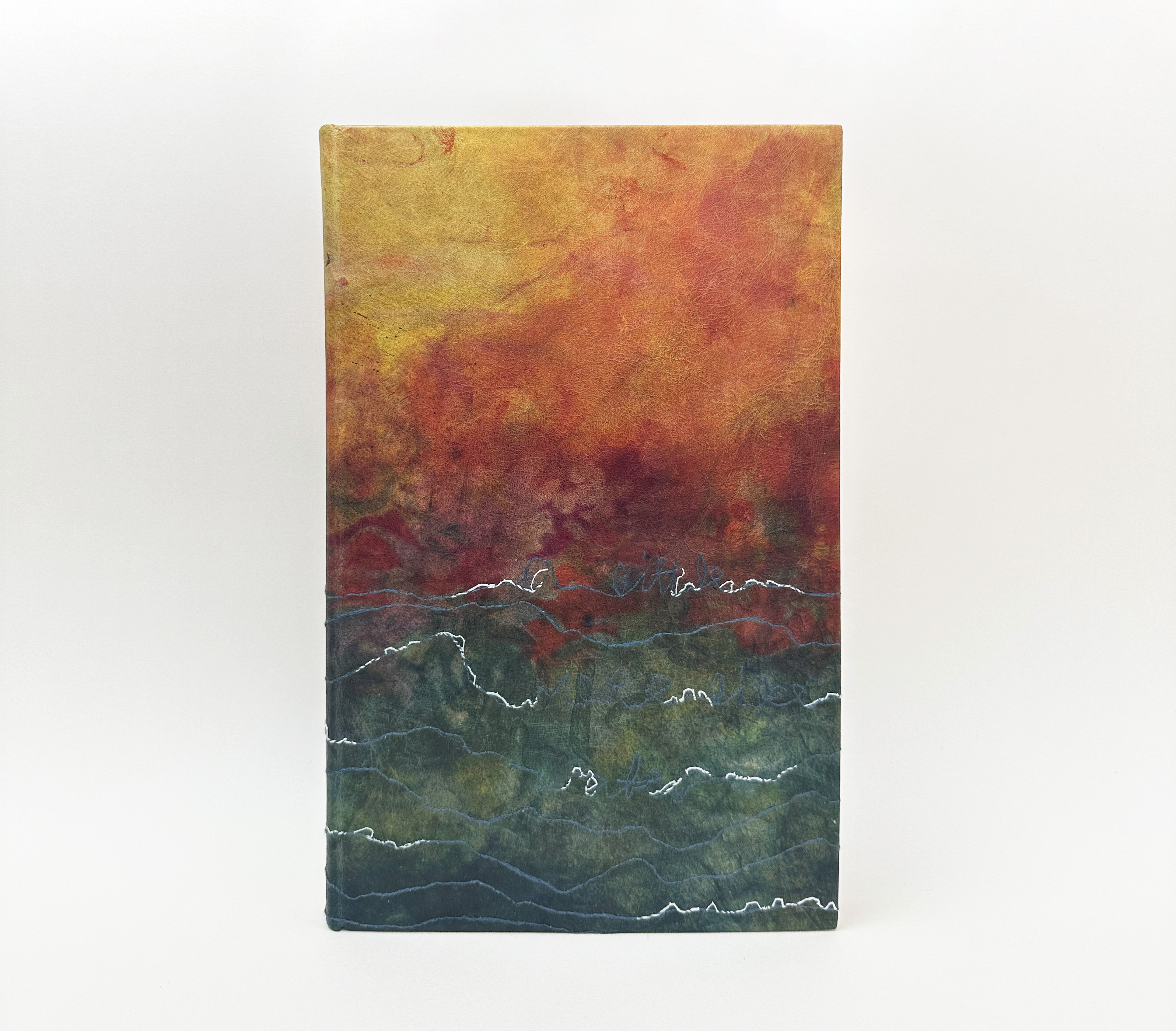 Front cover of A Little More Like Water binding on a white table.