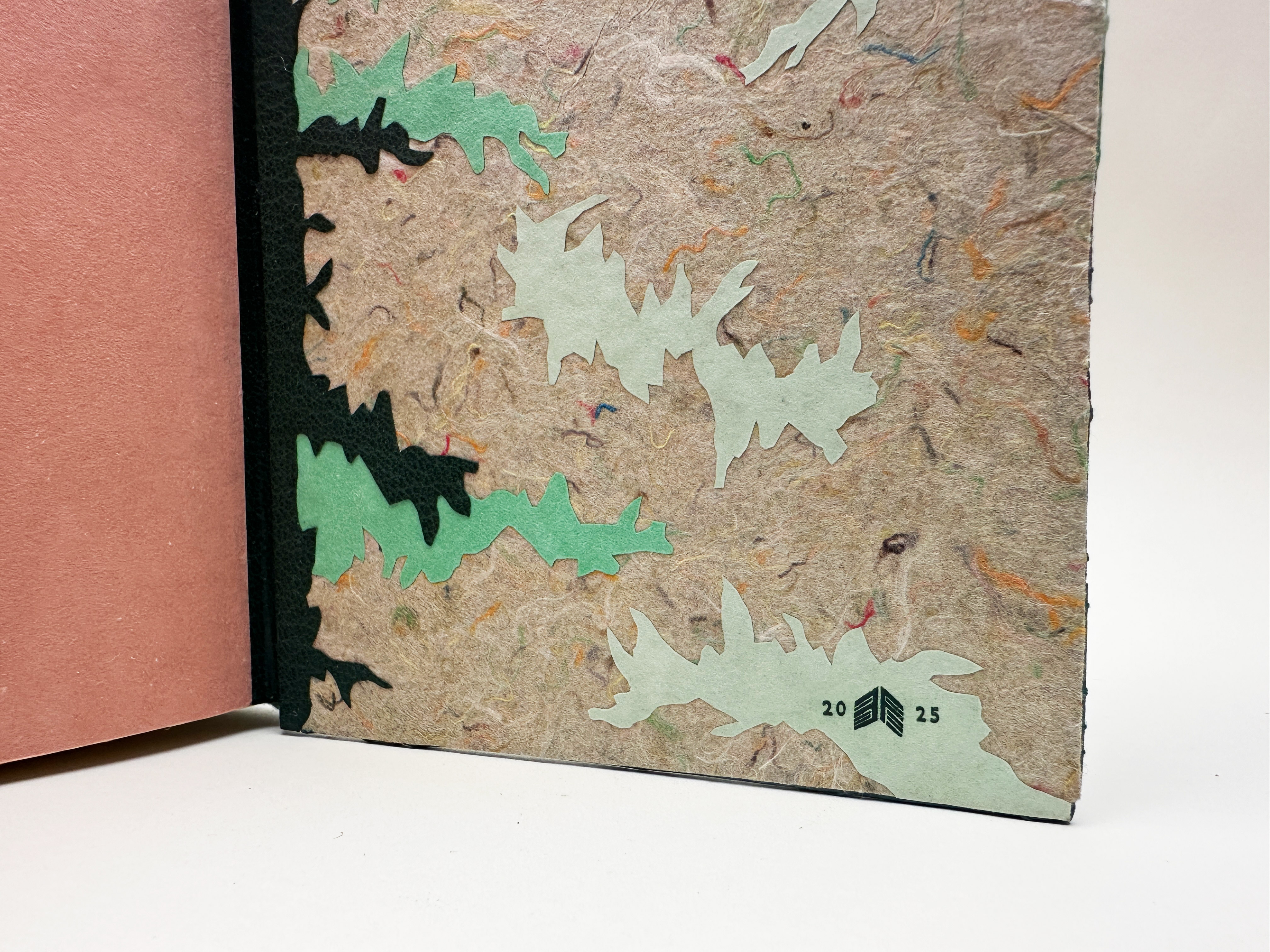 Close-up of signature label on back cover interior for Birds of Village and Field binding against a white backdrop