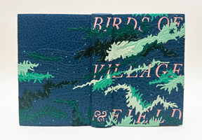 Cover of Birds of Village and Field binding on a white table.
