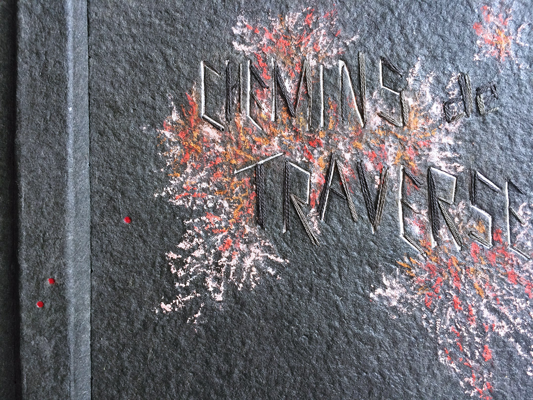 Close-up of front cover of Chemins De Traverse binding on a white table.