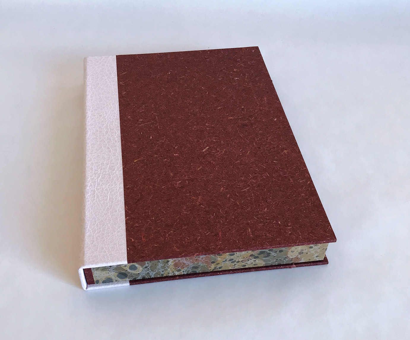 Front cover of box of Chemins De Traverse binding on a white table.