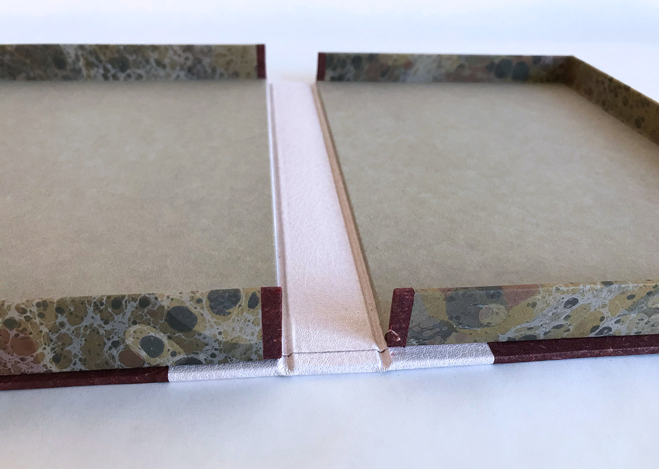 Box interior of Chemins De Traverse binding on a white table.