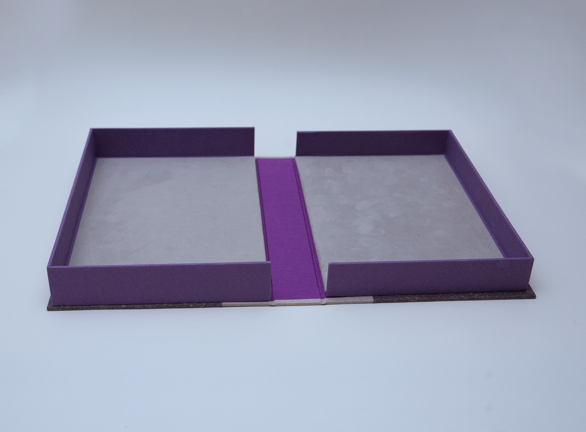 Box interior of Craft of the Dyer binding on a white table.