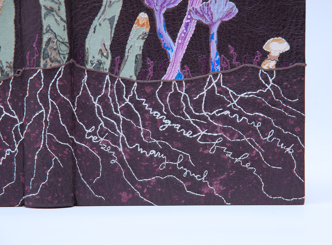 Close-up of front cover of Dark Archives binding on a white table.