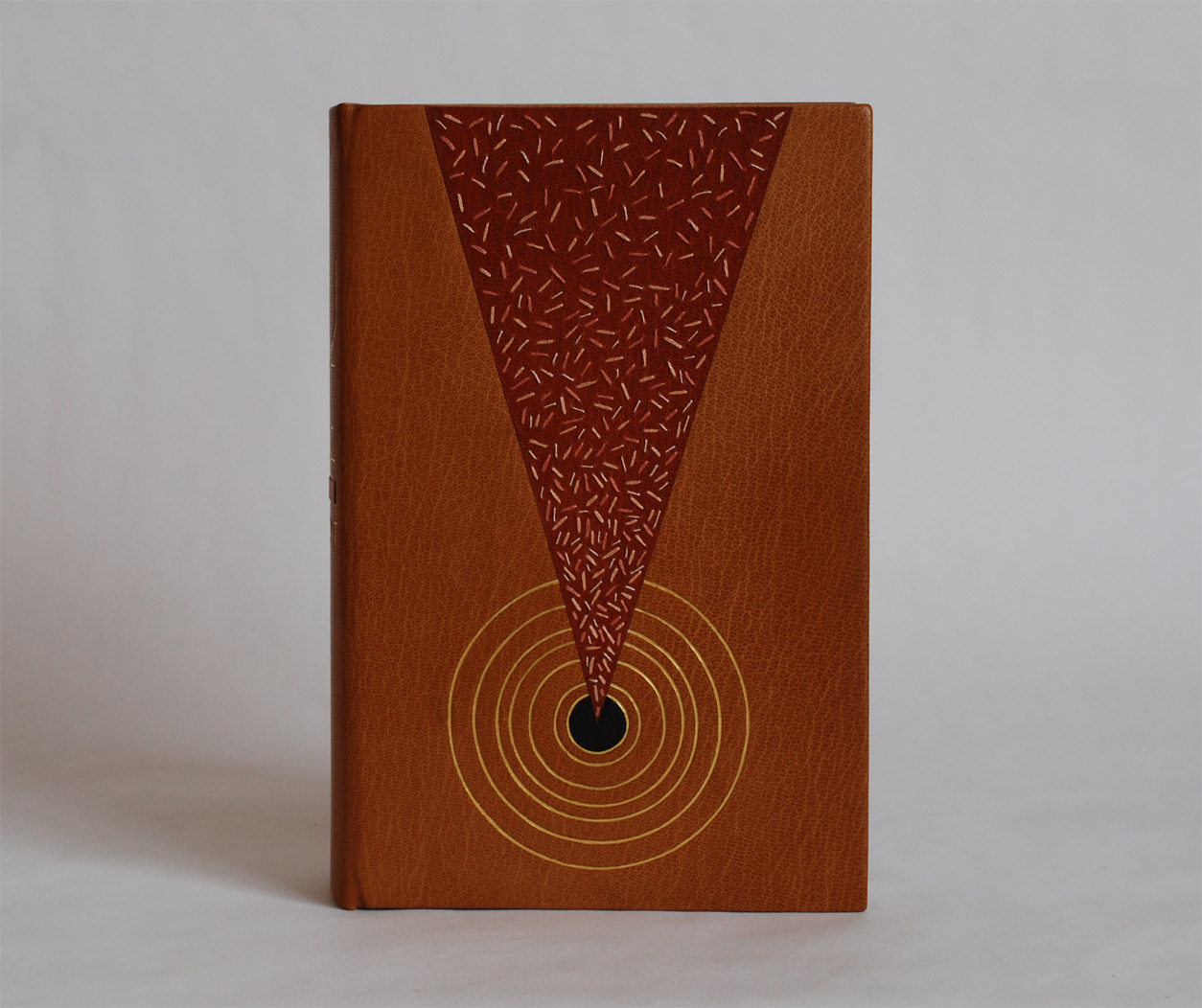 Front cover of Dune on a white table.