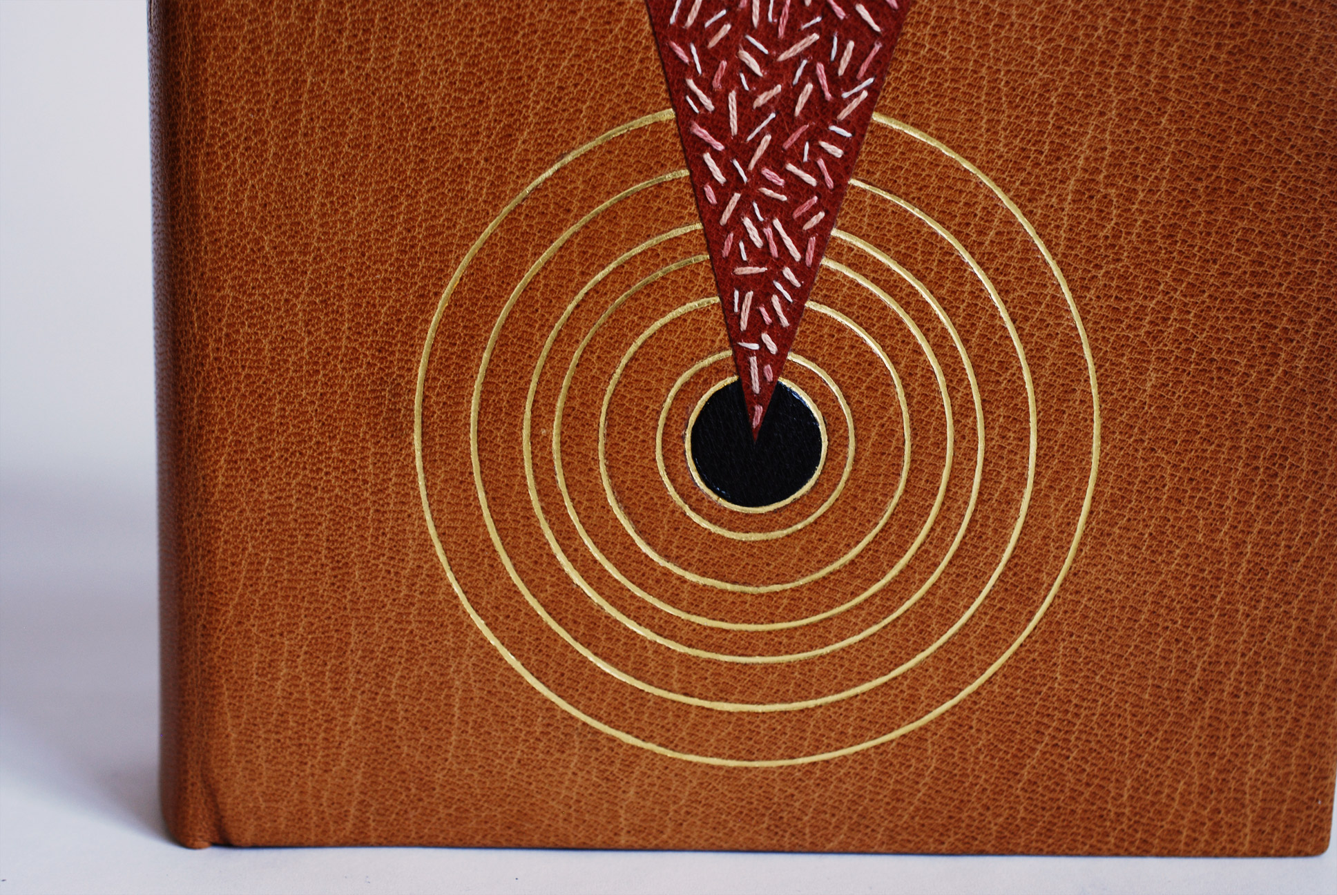 Close-up of front cover of Dune on a white table.