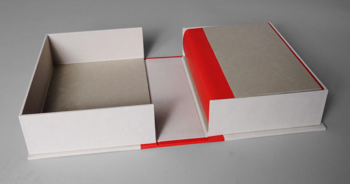 Box interior of Flatland: A Romance of Many Dimensions binding on a white table.