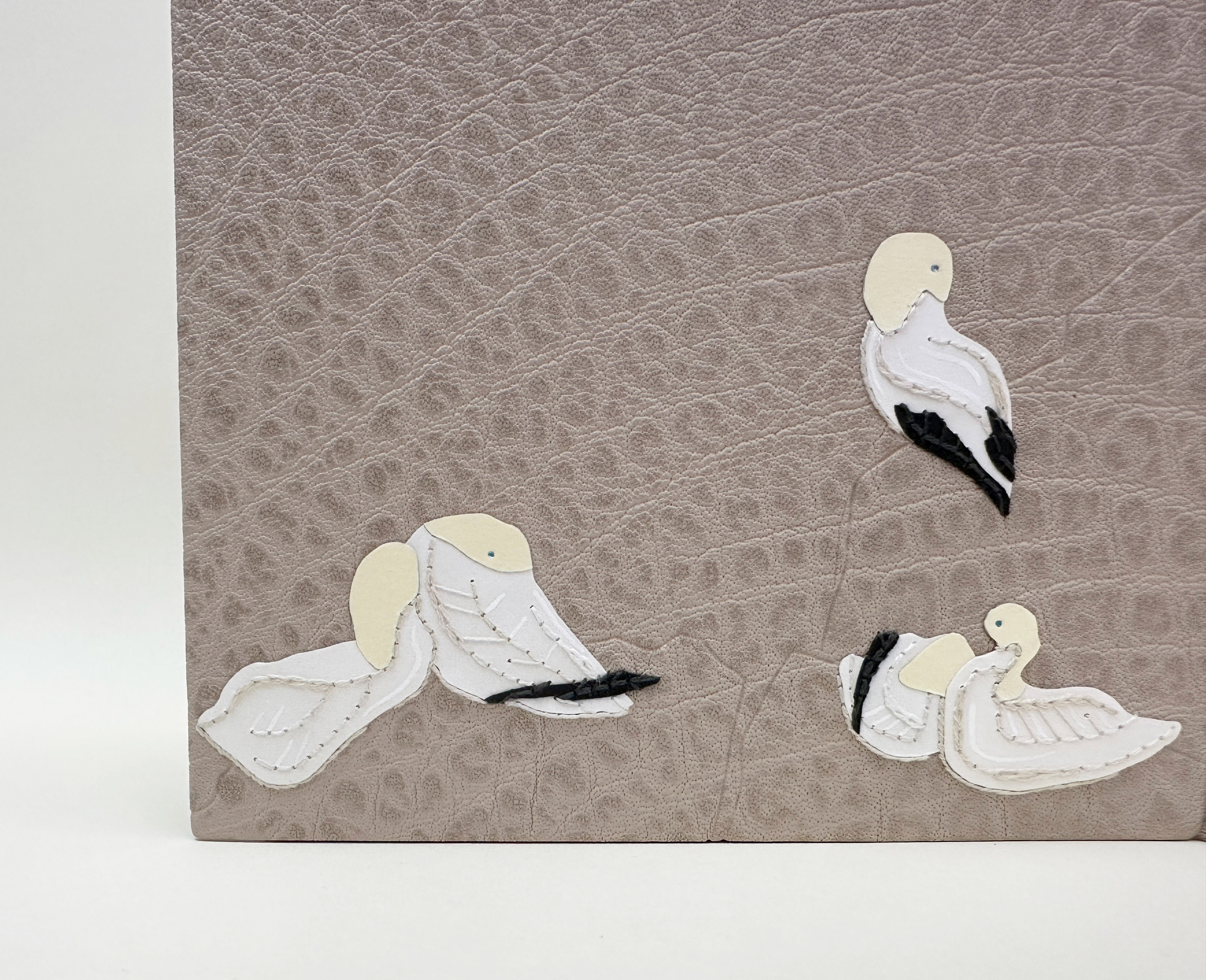 Close-up of back cover of An Idea of Geometry binding on a white table.