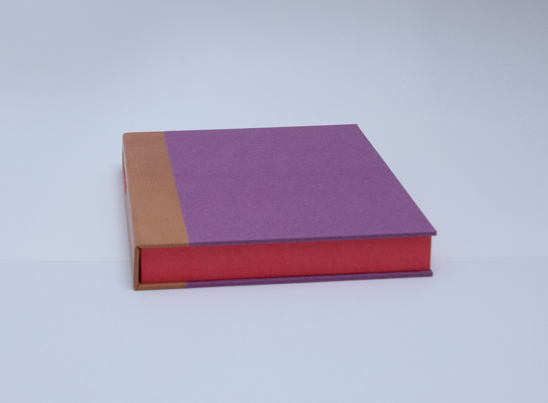 Box edge of Happy Abstract binding on a white table.
