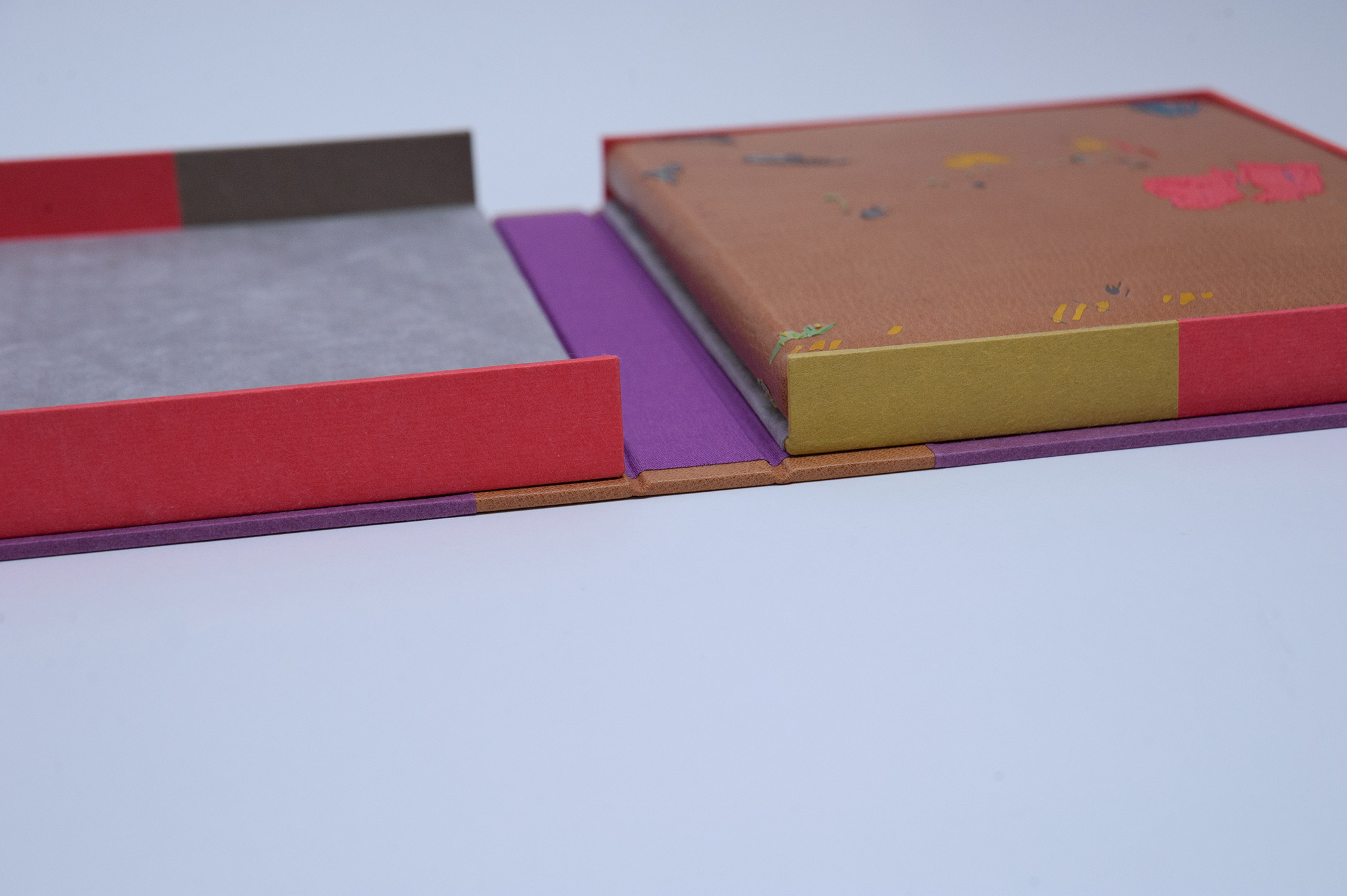 Box interior of Happy Abstract binding on a white table.