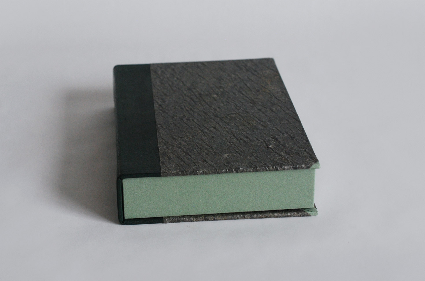 Box edge of Invisible Cities binding on a white table.