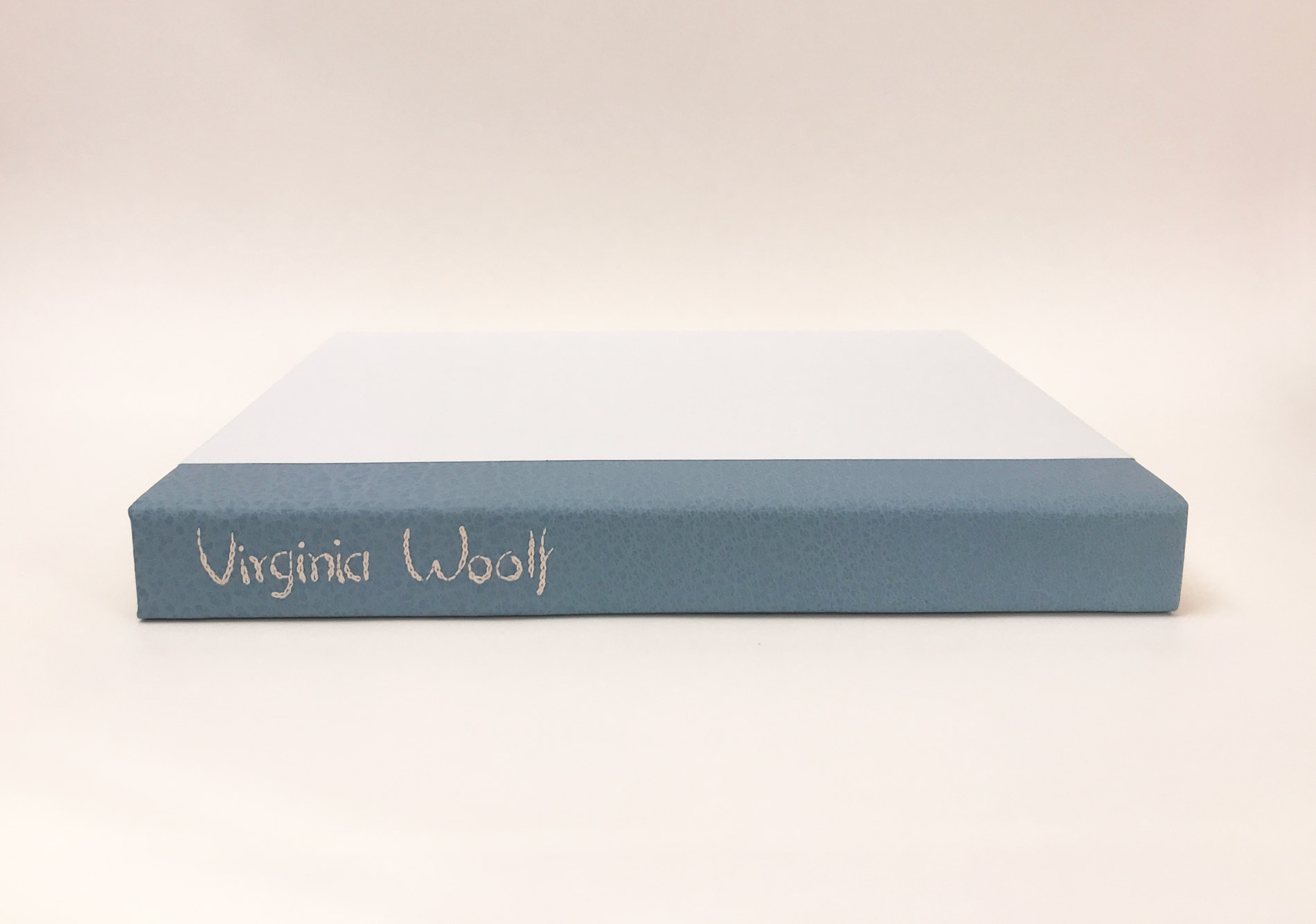 Box spine of Kew Gardens binding on a white table.