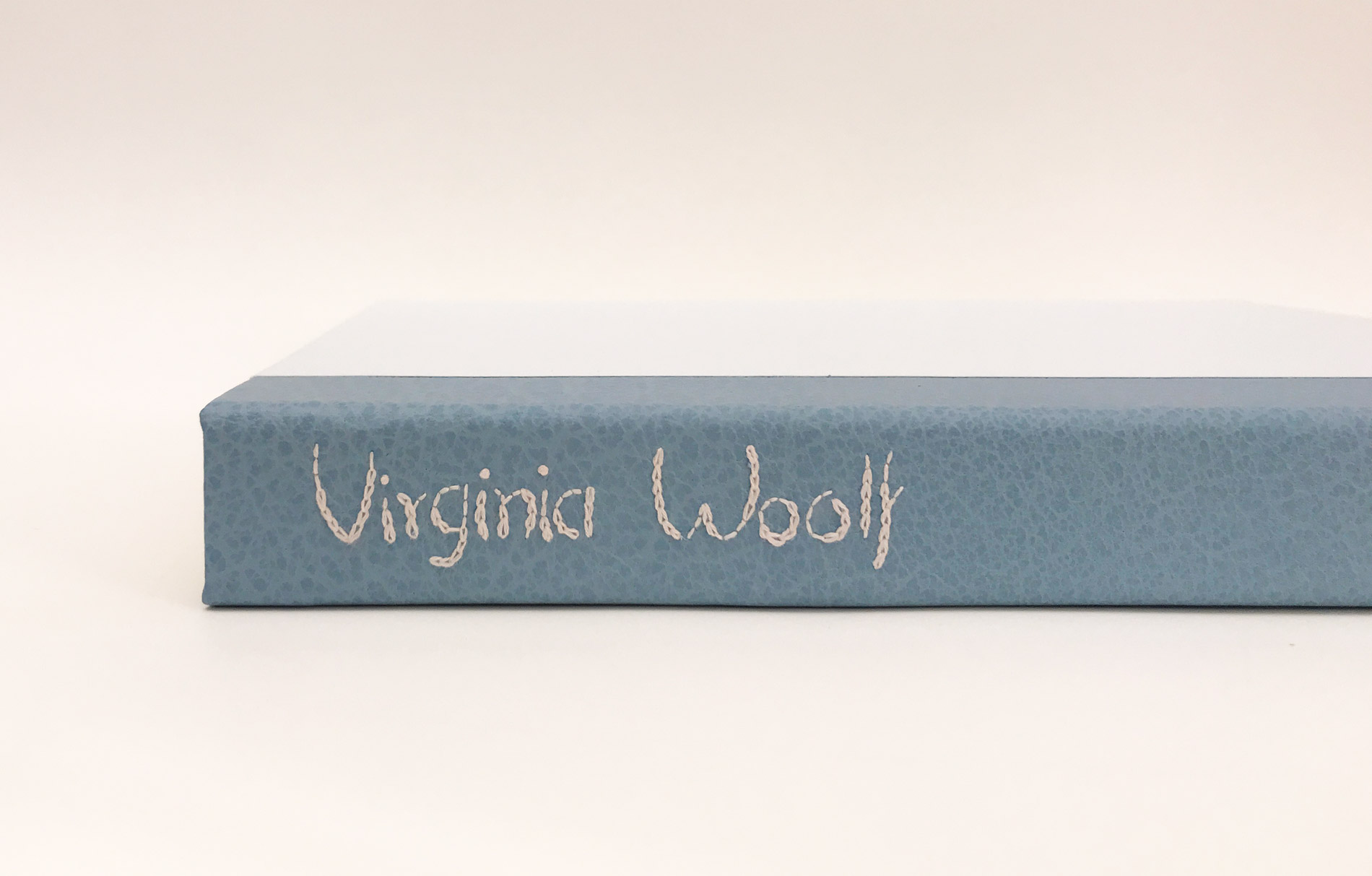Close-up of box spine of Kew Gardens binding on a white table.