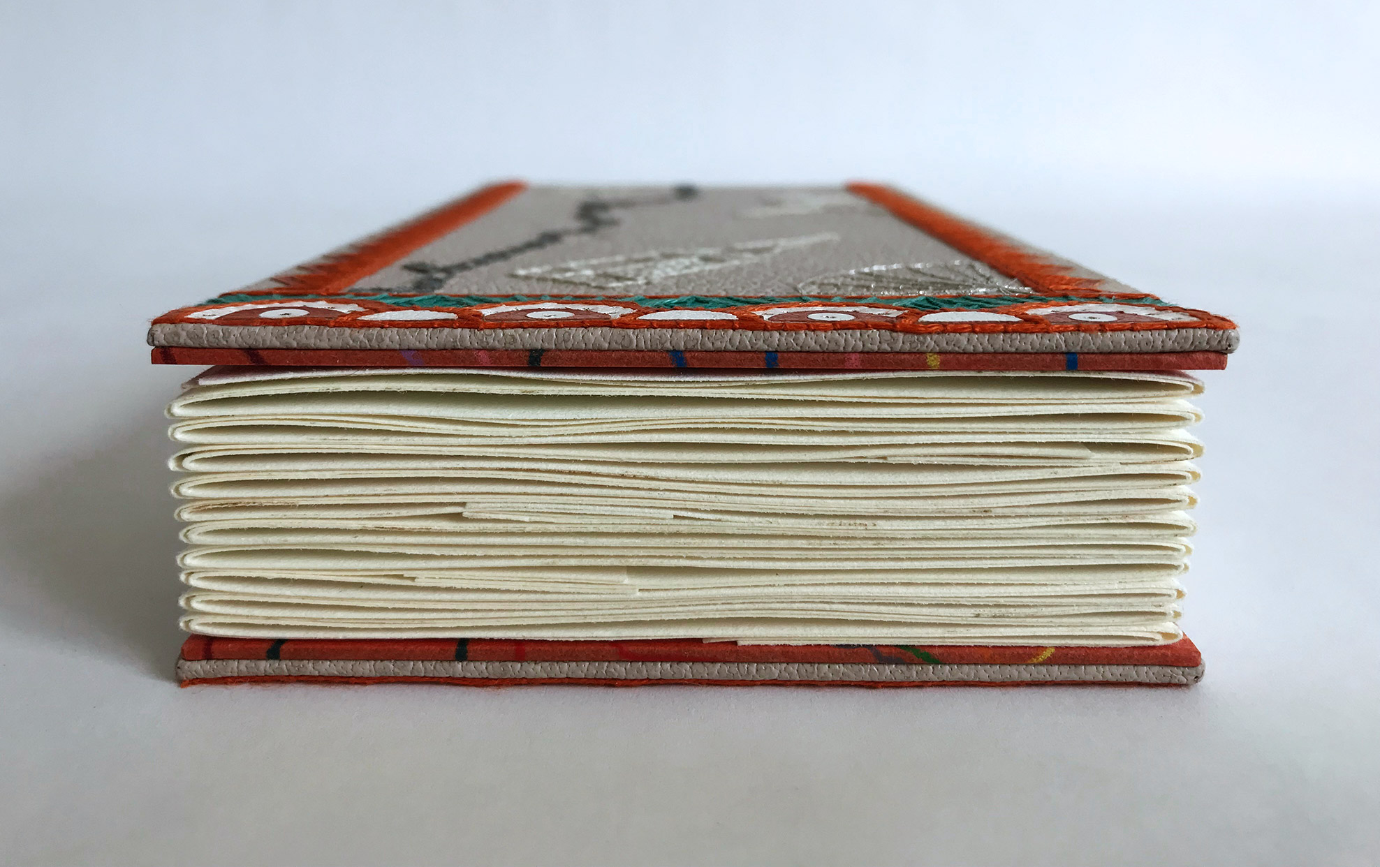 Edge of La Prose du Transsibérien binding on a white table.