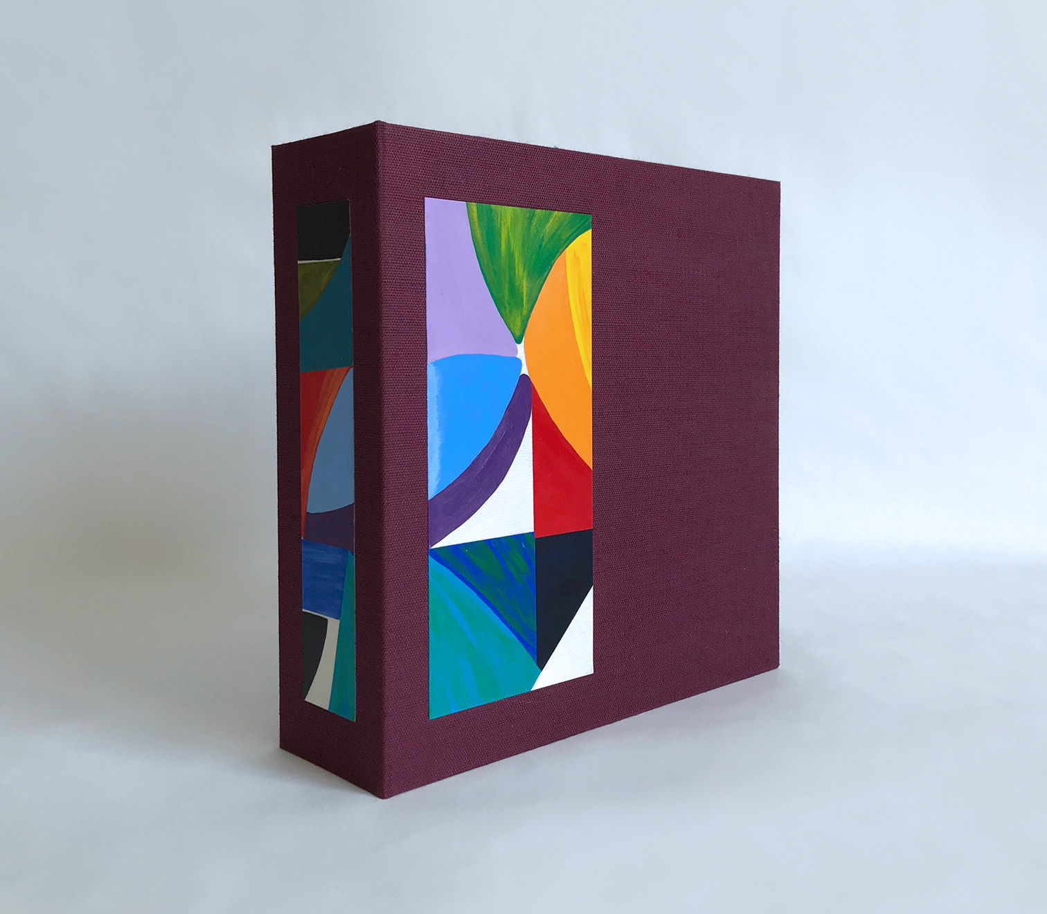 Box front cover of La Prose du Transsibérien binding on a white table.
