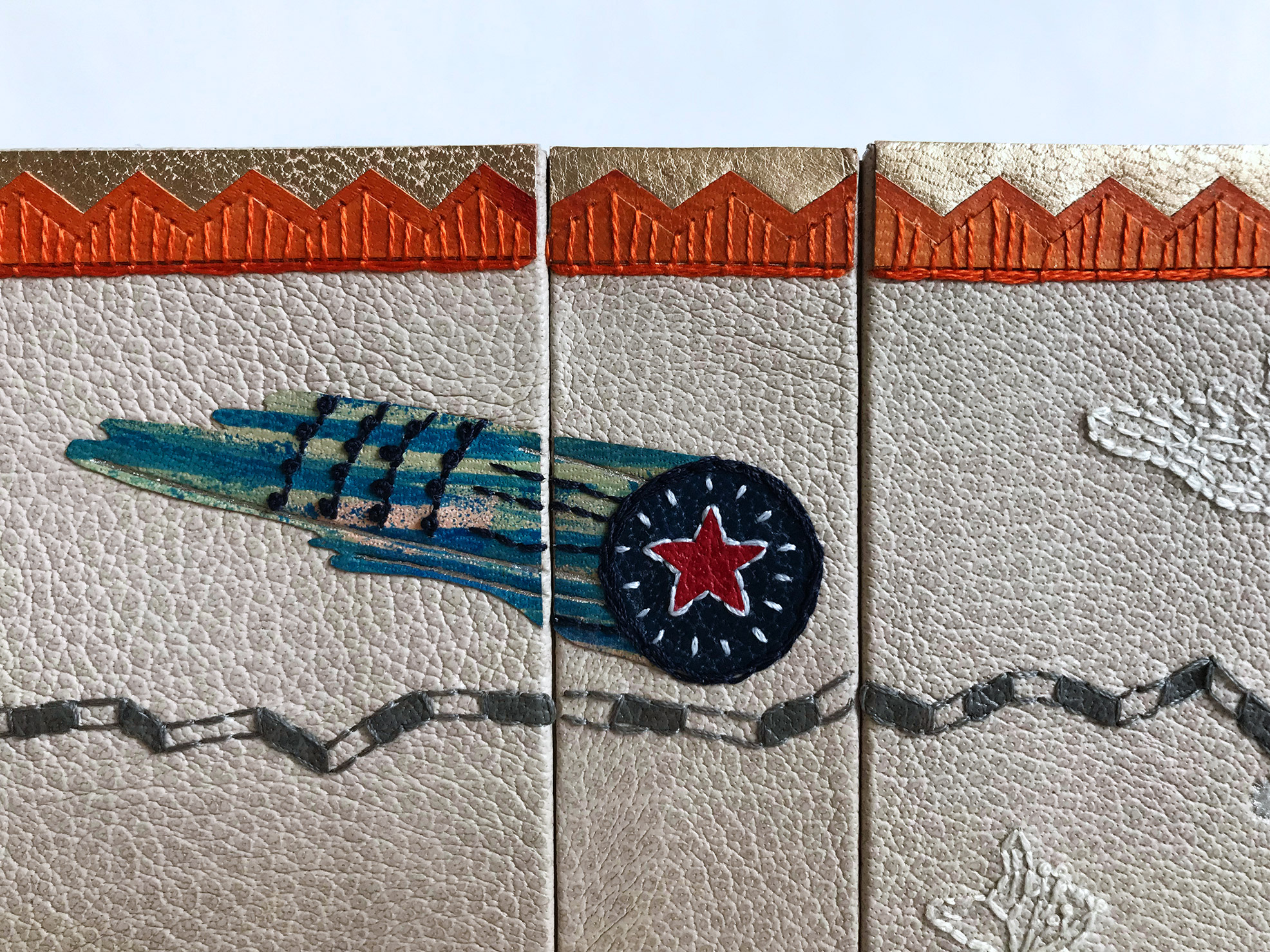 Close-up of front cover of La Prose du Transsibérien binding on a white table.
