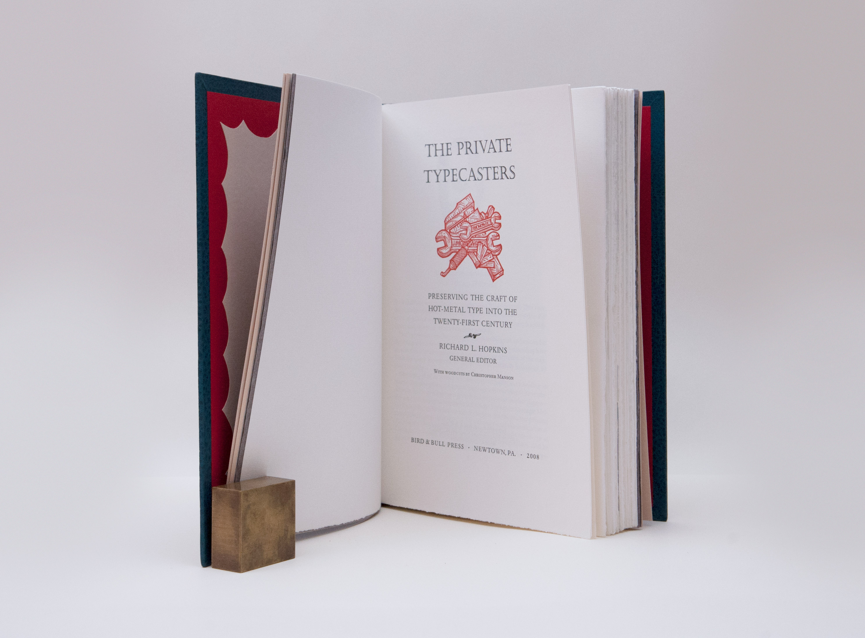 Interior of The Private Typecasters binding on a white table.