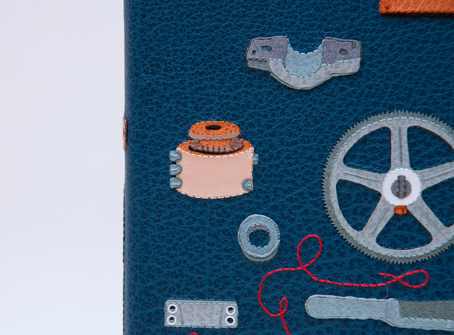 Close-up of front cover of The Private Typecasters binding on a white table.