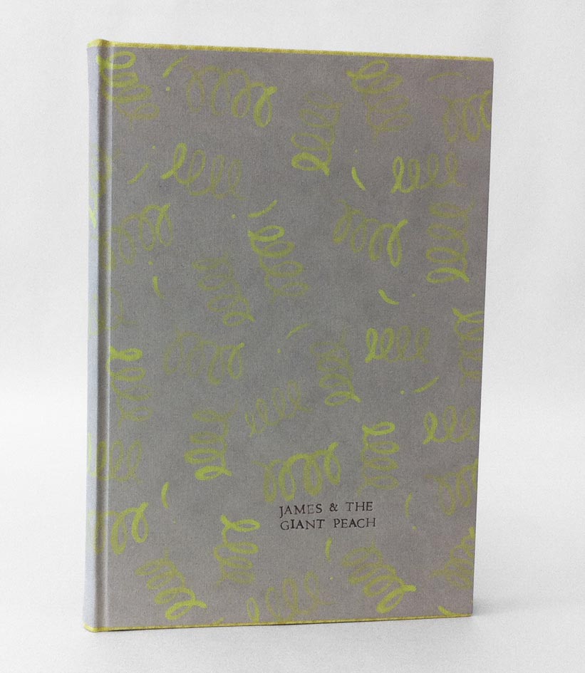 Front cover of James and the Giant Peach binding on a white table.