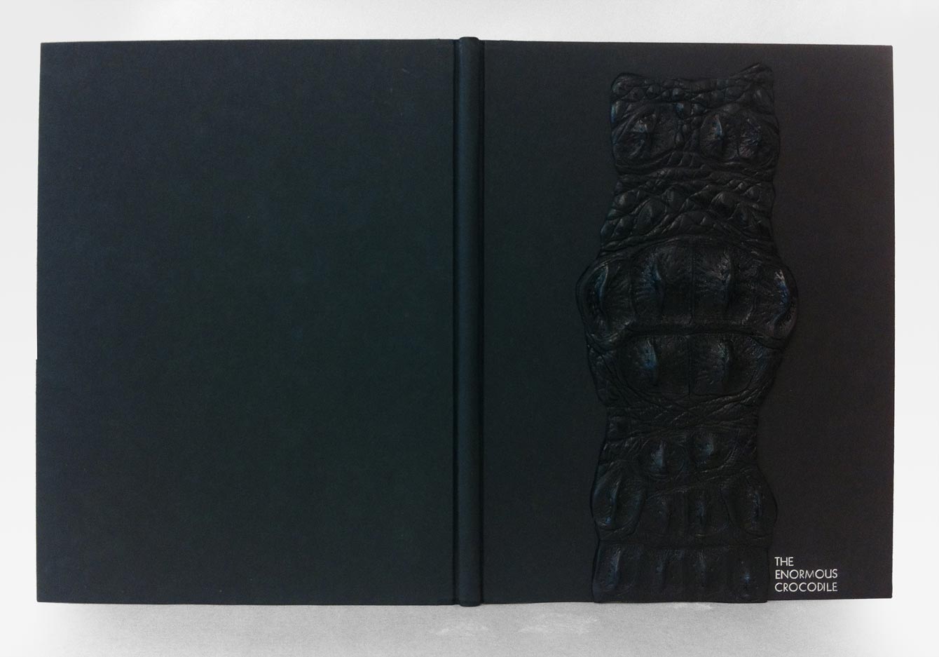 Front cover of The Enormous Crocodile binding on a white table.