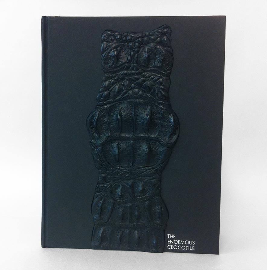 Front cover of The Enormous Crocodile binding on a white table.