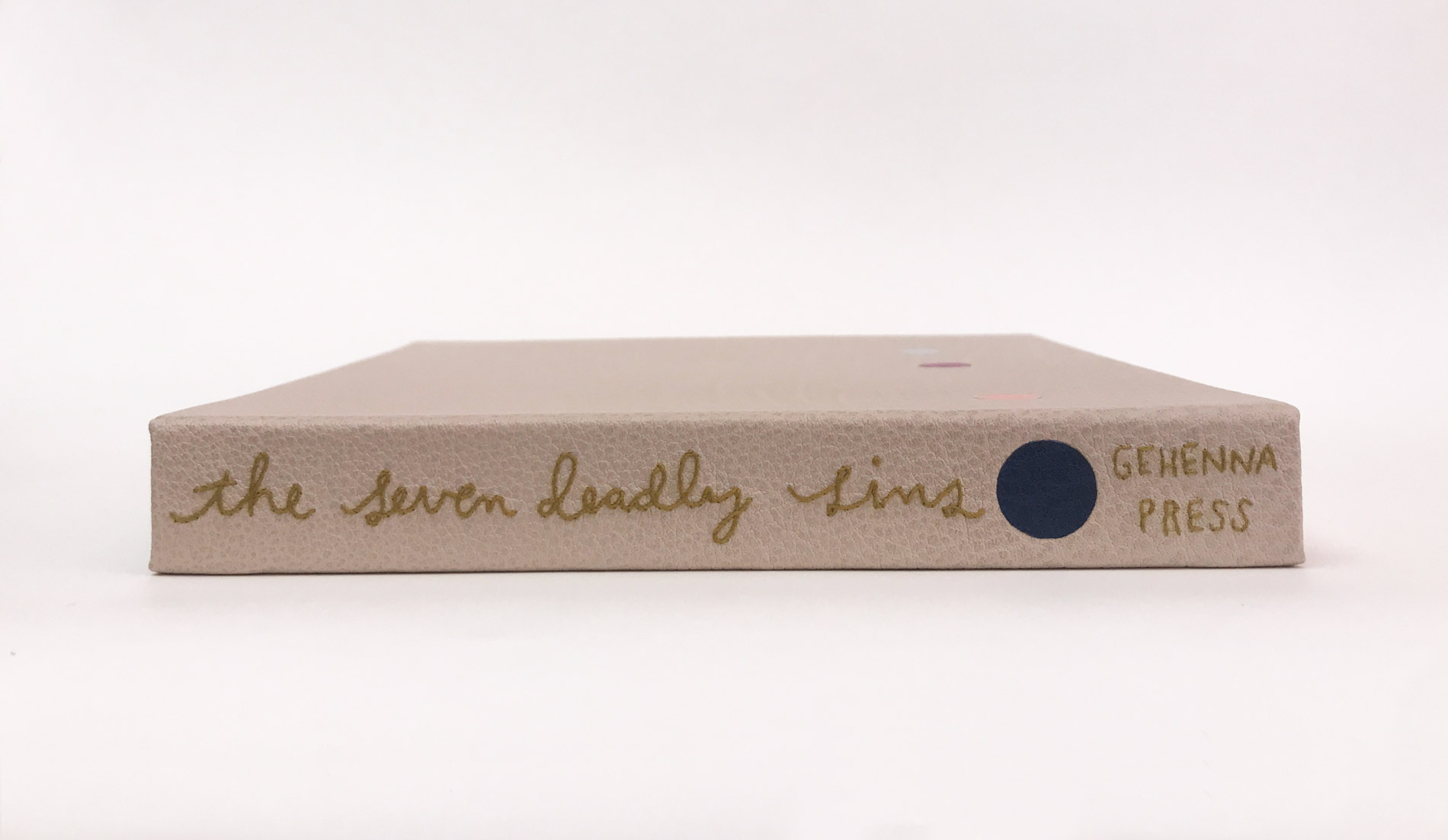 Box spine of The Seven Deadly Sins binding on a white table.