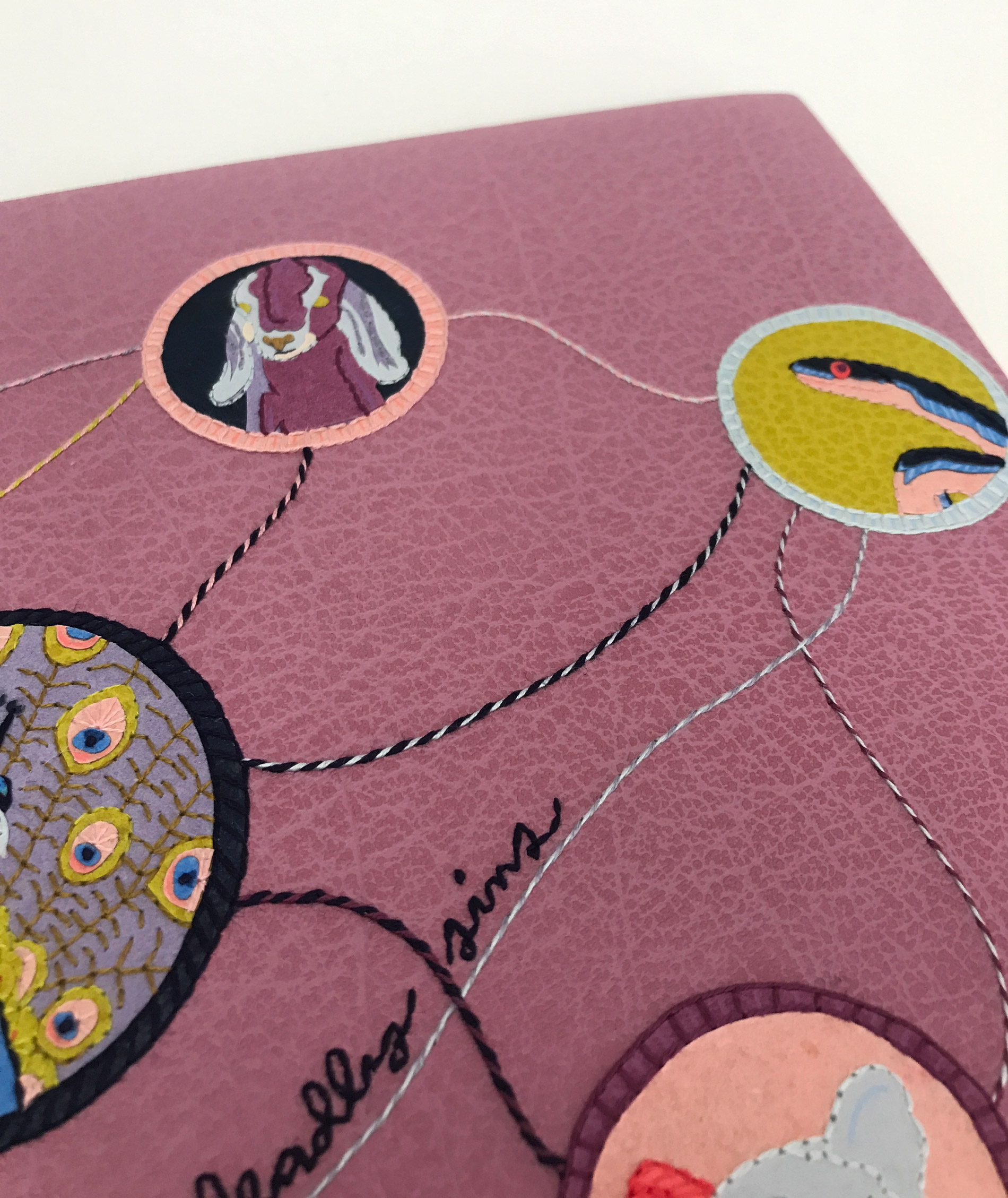 Close-up of front cover of The Seven Deadly Sins binding on a white table.