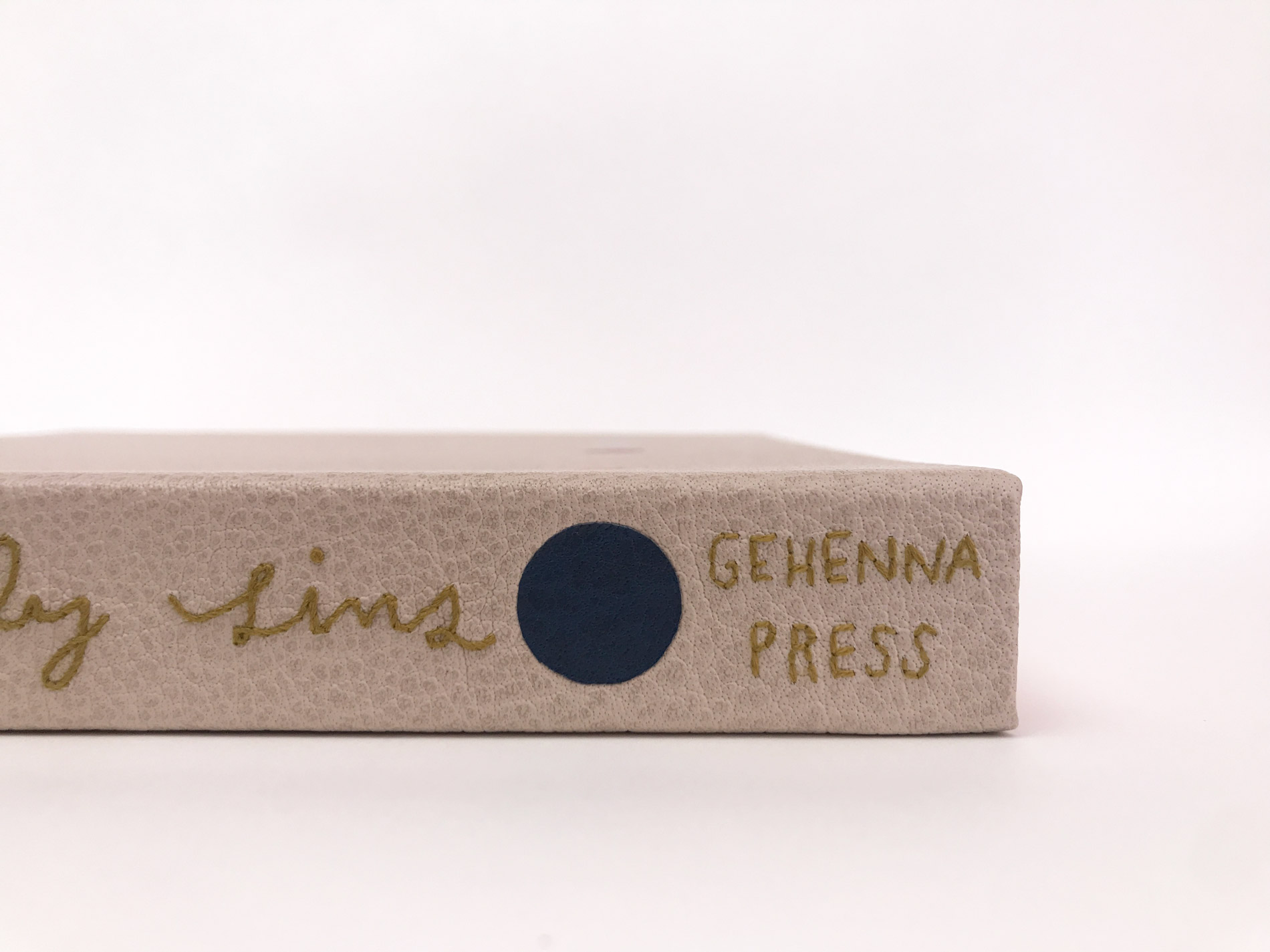 Close-up of box spine of The Seven Deadly Sins binding on a white table.
