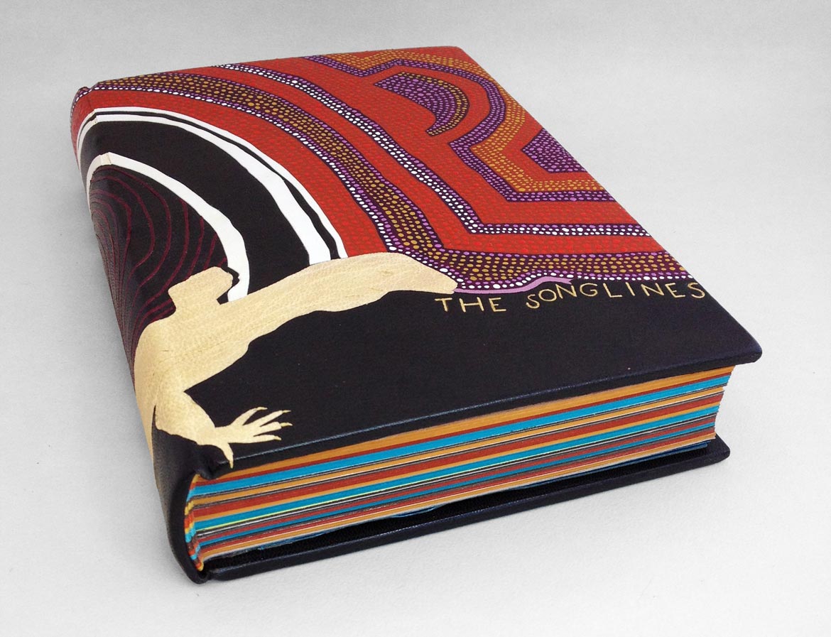 Front cover of The Songlines binding on a white table.