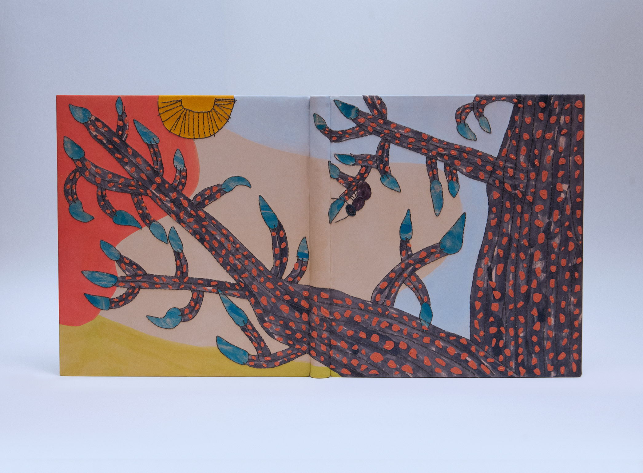 Front cover of Stuart Williams: His World and His Art binding on a white table.