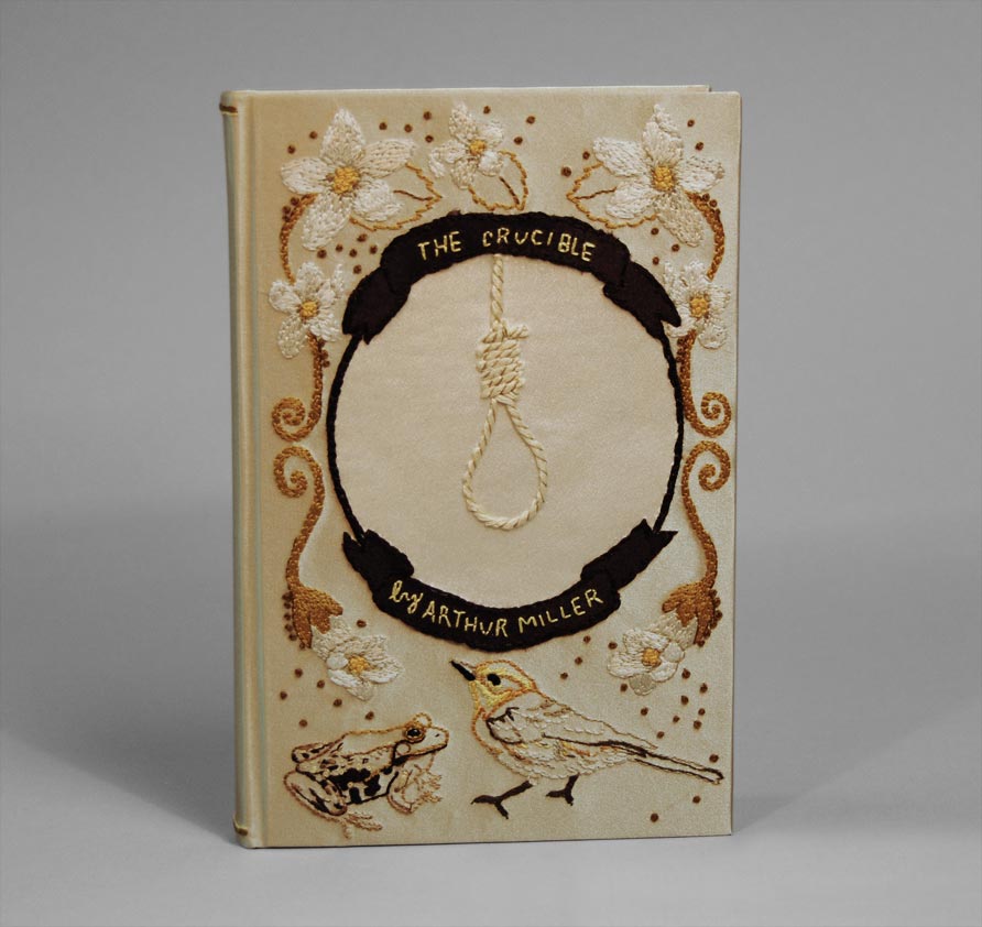 Front cover of The Crucible binding on a white table.