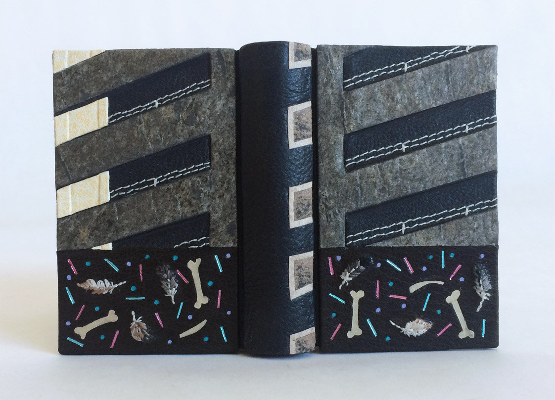 Front cover of The Island binding on a white table.