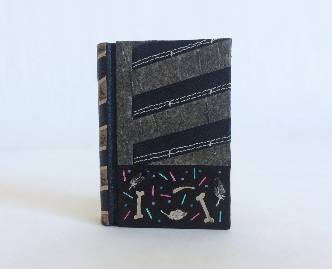 Front cover of The Island binding on a white table.