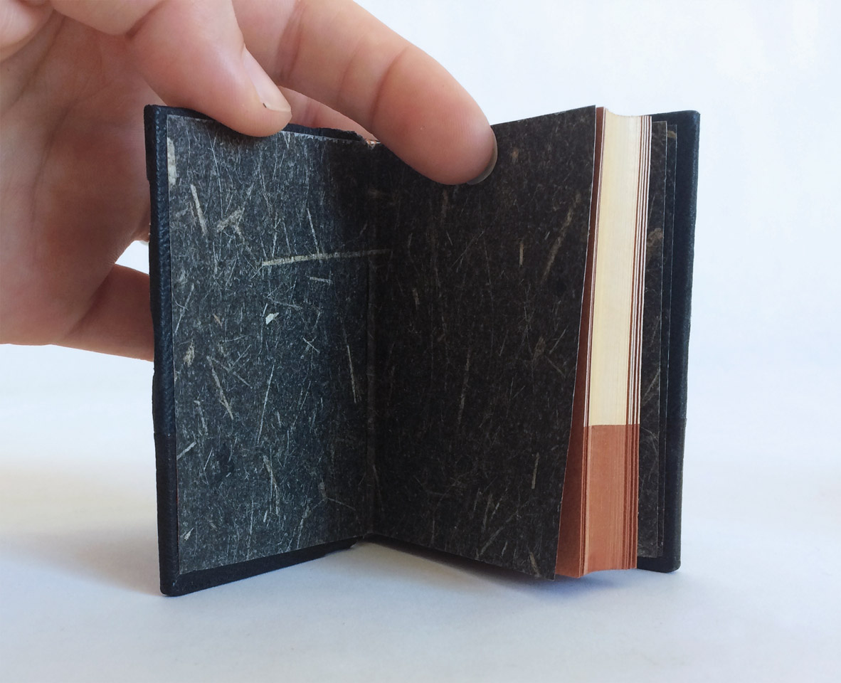 Interior of The Island binding on a white table.