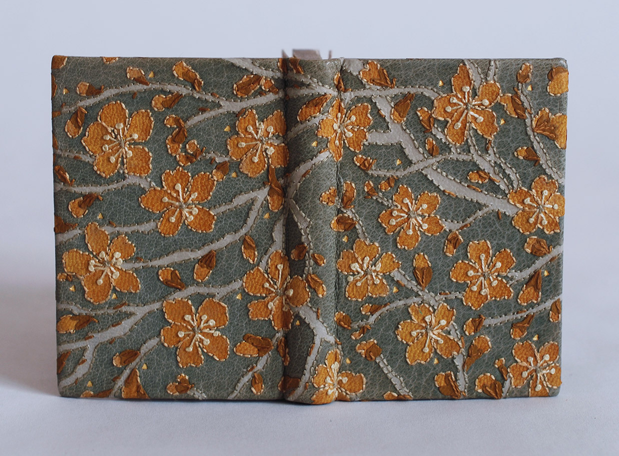 Front cover of The New House binding on a white table.