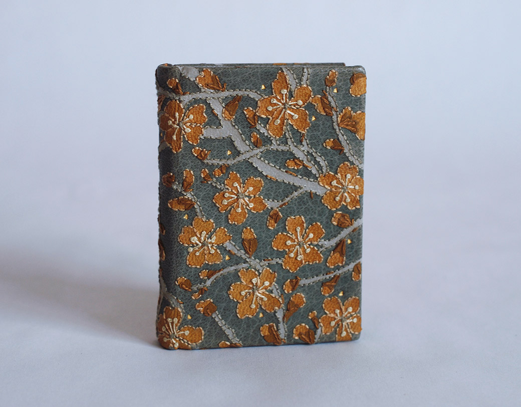 Front cover of The New House binding on a white table.