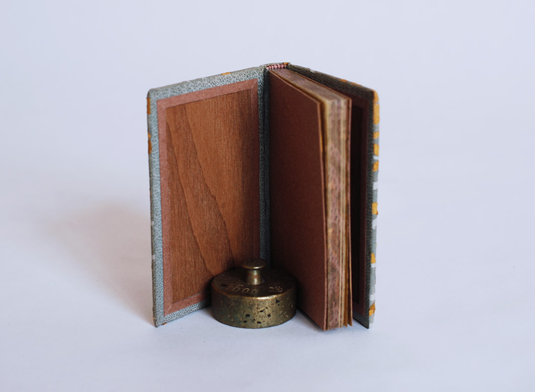 Interior of The New House binding on a white table.