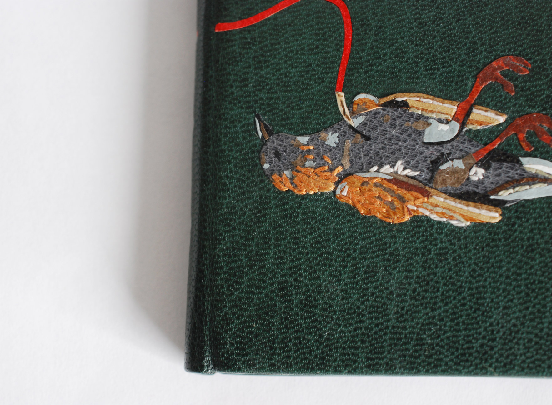 Close-up of front cover of The Nightingale and the Rose binding on a white table.