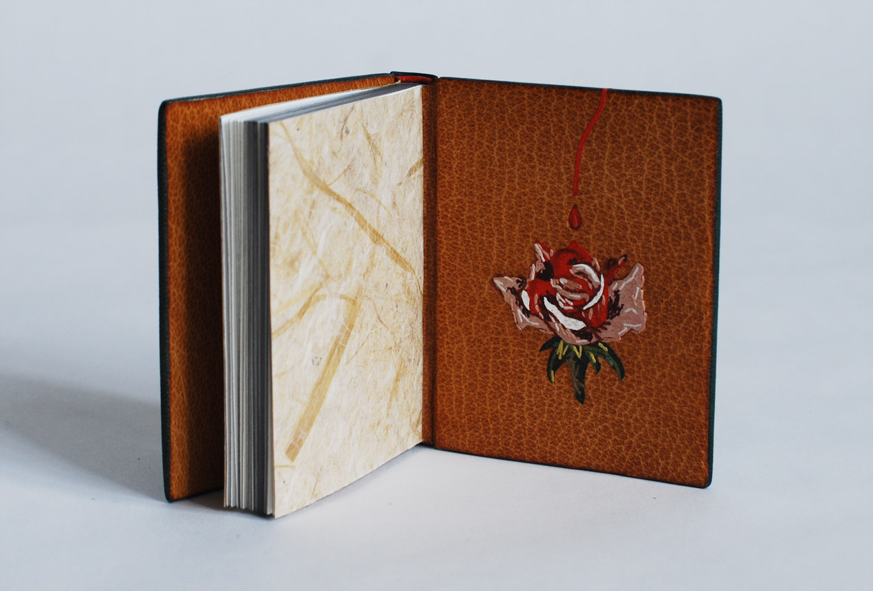 Interior of The Nightingale and the Rose binding on a white table.