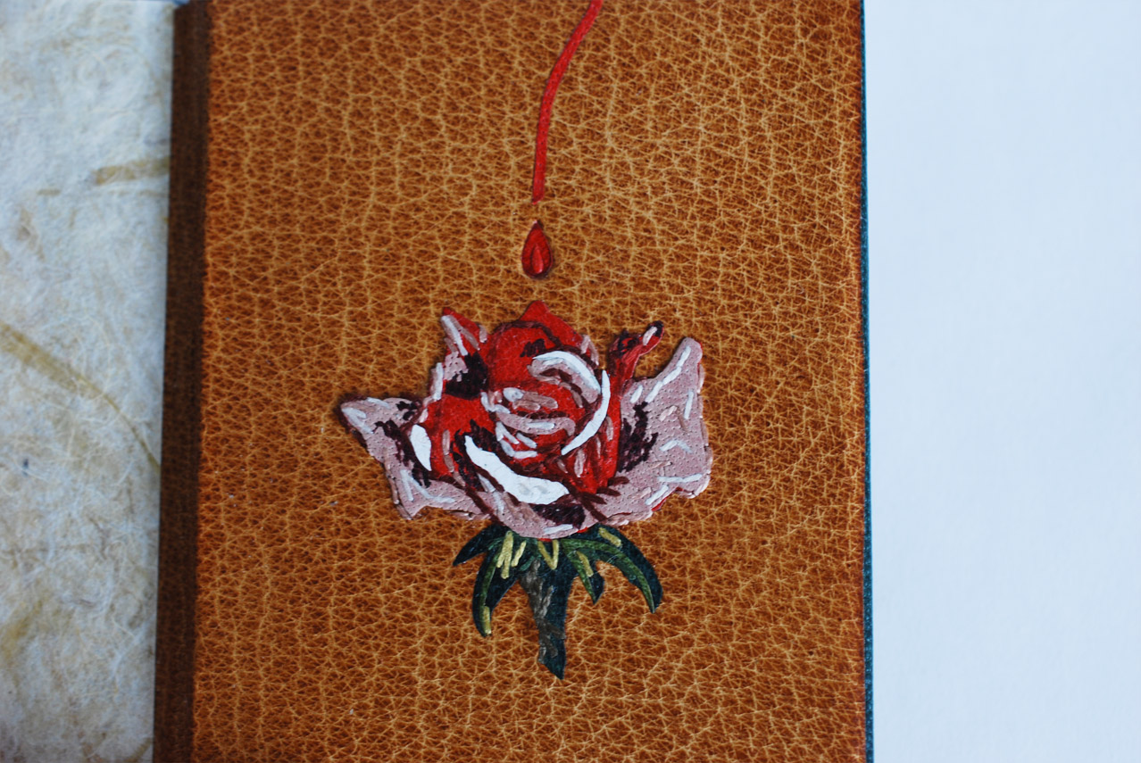 Interior of The Nightingale and the Rose binding on a white table.