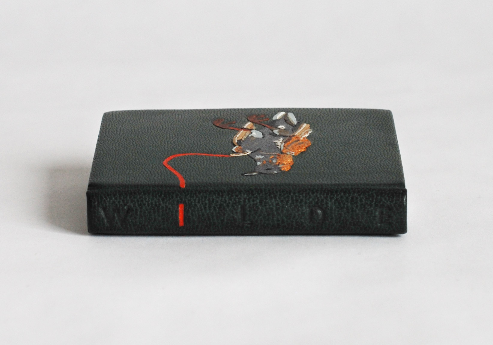 Spine of The Nightingale and the Rose binding on a white table.
