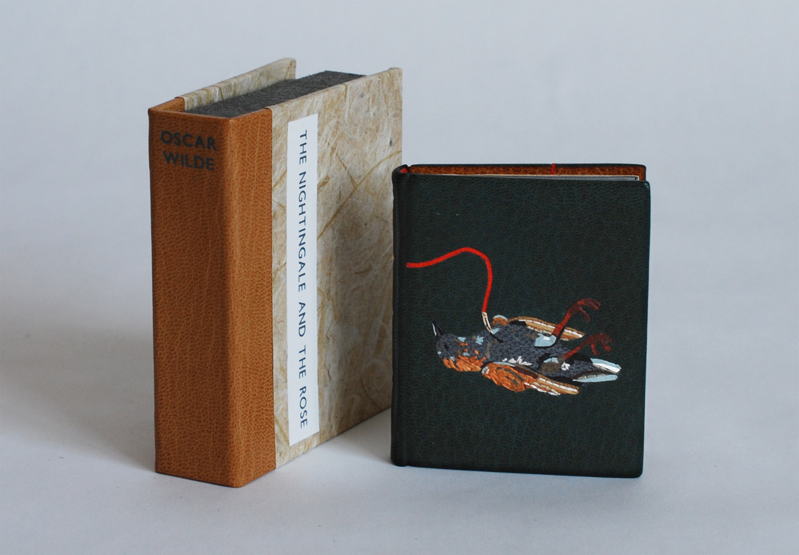 Box and The Nightingale and the Rose binding standing on a white table.