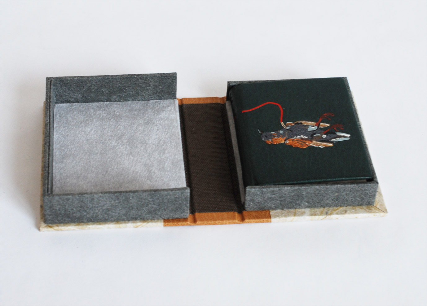 Box interior of The Nightingale and the Rose binding on a white table.