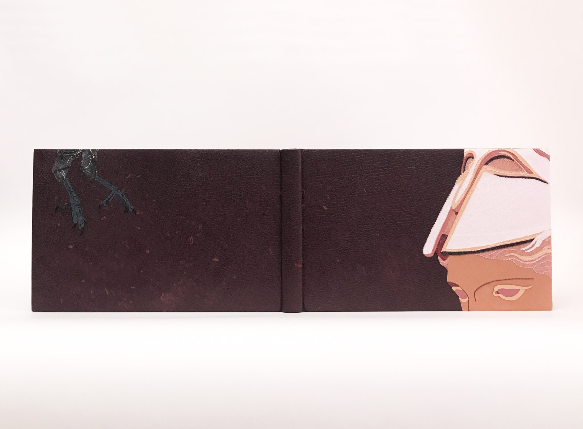 Front cover of The Raven binding on a white table.
