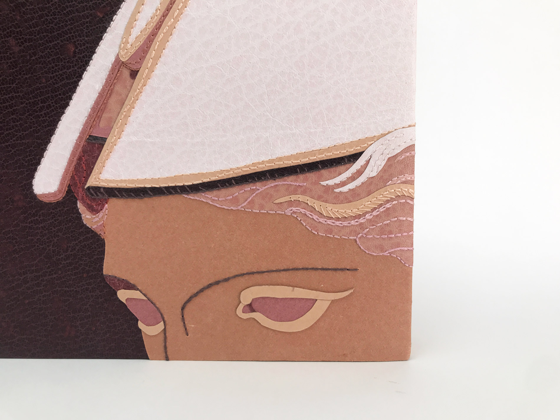 Close-up of front cover of The Raven binding on a white table.