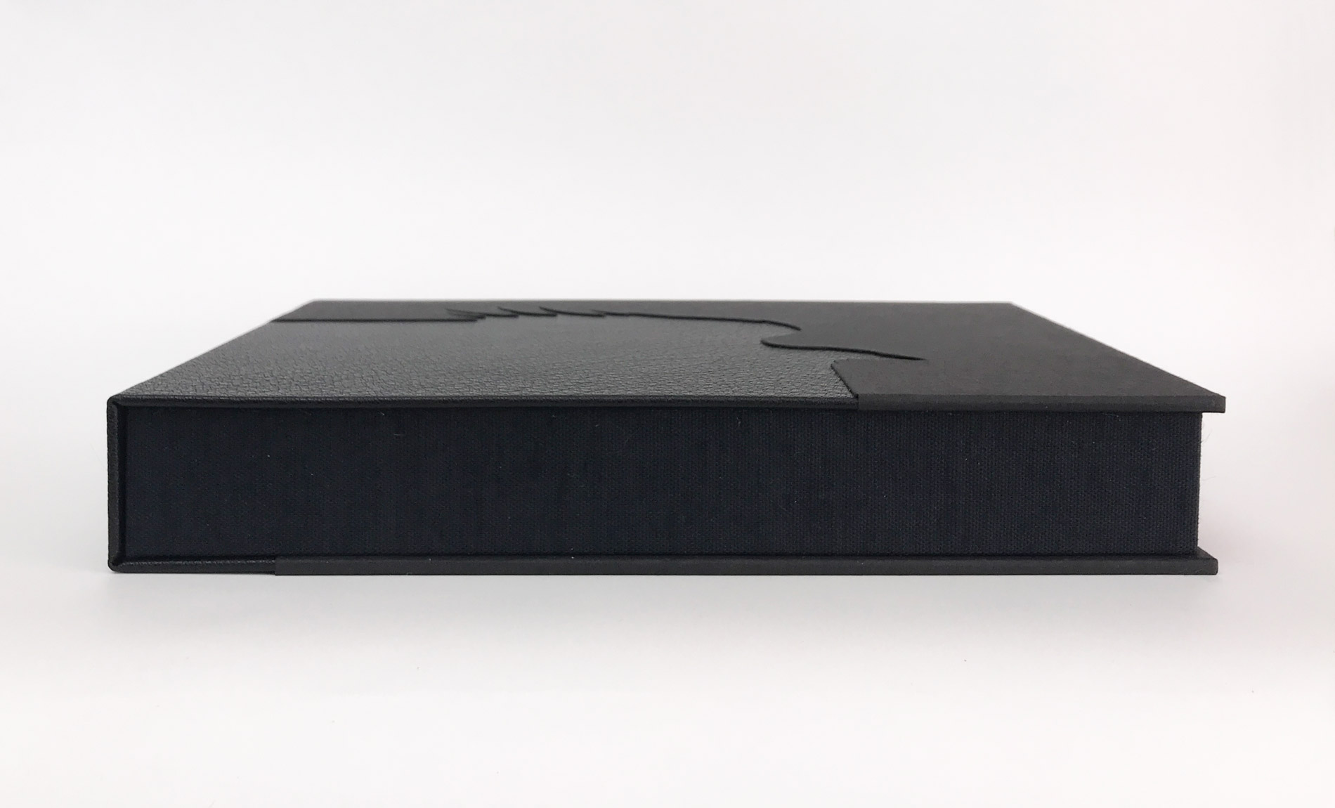 Box edge of The Raven binding on a white table.