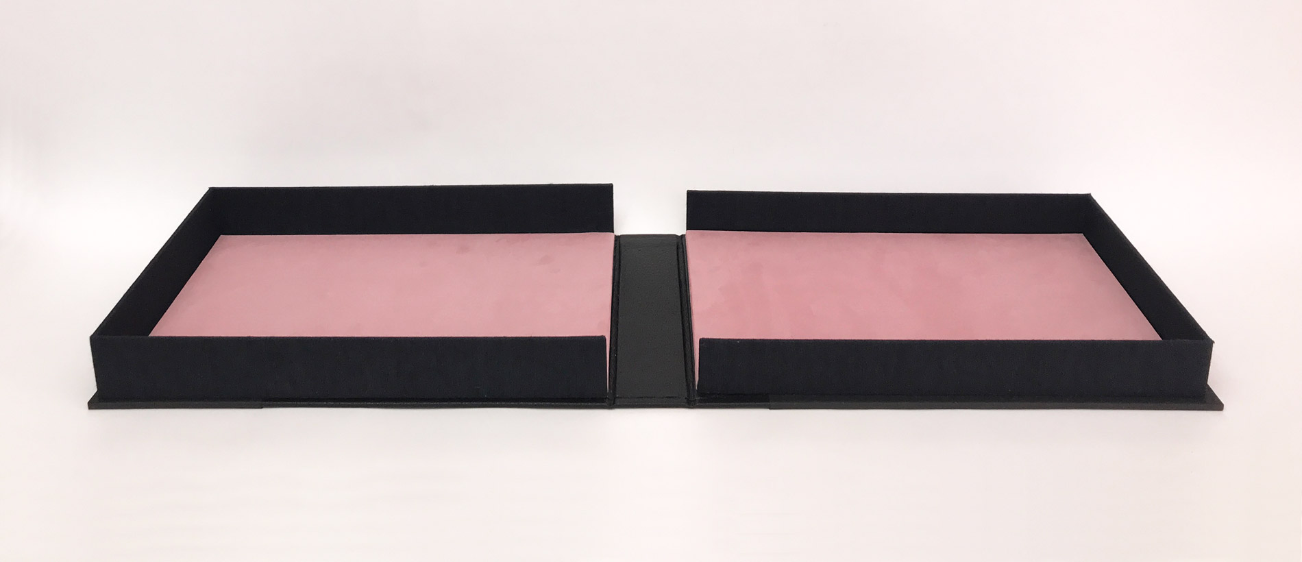 Box interior of The Raven binding on a white table.