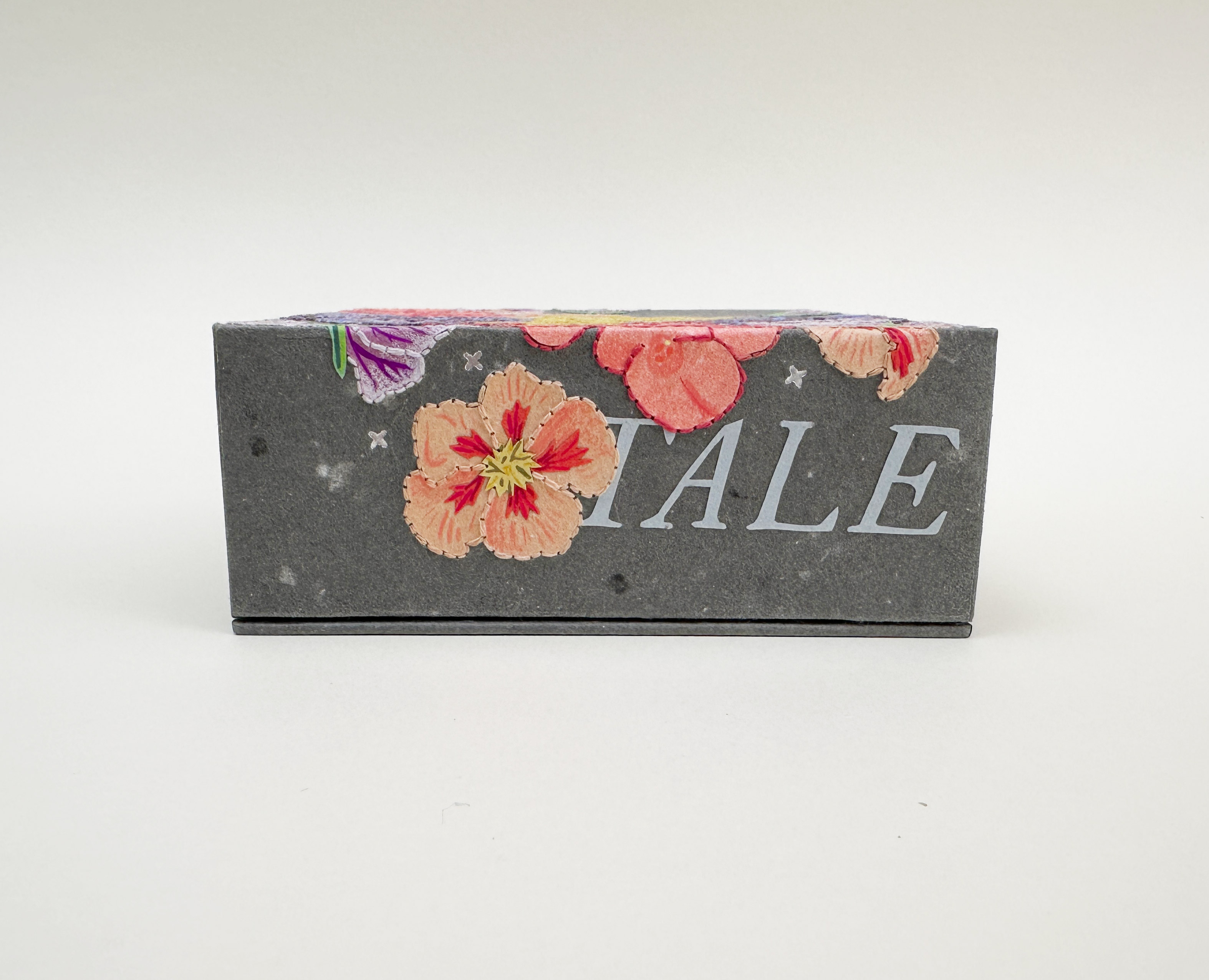 Close-up of box spine of Roadkills binding on a white table.